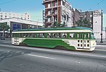 Streetcar No. 1006 of the San Francisco Muncipal Railway in 1985. The streetcar is painted green and cream.