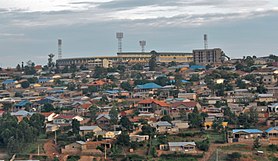 Photograph of houses in Remera on the hillside, with the Amahoro stadium visible at the top of the hill