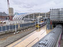The partially complete new roof at Manchester Victoria in July 2014 Manchester Victoria new roof exterior July 2014.jpg