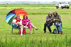 Two couples watching a horse race (or not)