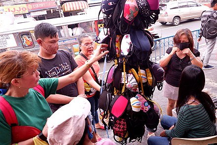 Cloth face masks draw the attention of customers at the Munoz Market in Quezon City due to the limited supply and higher price of surgical masks. Philippines Coronavirus 01.jpg