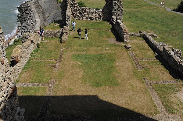 Interior of the ruined church, looking eastwards from an elevated gallery between the towers in 2015. A curved strip of concrete towards the top of th