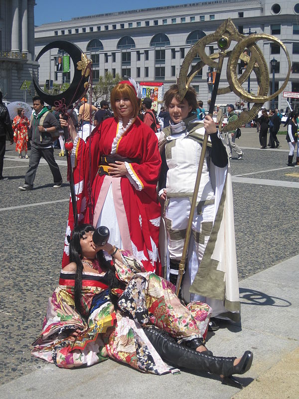 A group cosplaying three Clamp characters: Sakura (top left) and Syaoran (top right) from Tsubasa: Reservoir Chronicle; and Yuko Ichihara (bottom) fro