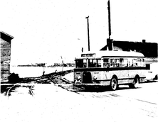 Sturgeon Bay Transit, Inc. bus crossing the tracks near the west side bridge approach, 1943