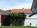 English: Former synagogue in the village of Dub, Prachatice District, Czech Republic, nowadays house No 10 (the one with the red roof at the back) Čeština: Pohled z ulice k bývalé synagoze v městysu Dub, okres Prachatice, nyní dům č.p. 10 (červená střecha vzadu)