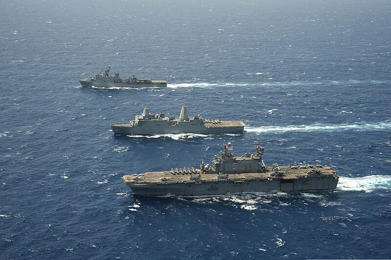 File:The amphibious dock landing ship USS Rushmore (LSD 47), top, amphibious transport dock ship USS Green Bay (LPD 20), center, and amphibious assault ship USS Peleliu (LHA 5) steam in formation in the Pacific Ocean 130423-N-ZM744-1427.jpg