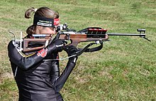 German Tina Bachmann with her Anschutz Fortner biathlon rifle in .22 Long Rifle. Notice her support hand holding against a raiser block. Tina Bachmann.JPG