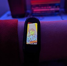 A picture of a Xiaomi Mi Smart Band 5 in a darkened room Xiaomi Mi Smart Band 5 at night.jpg