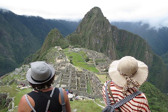 Two young ladies contemplating the beauty of Machu Picchu