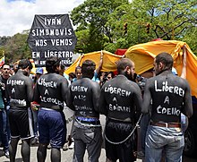 Protesters painted black and chained while demonstrating during the "March of the Brave" on 1 June. 1 June 2014 Venezuelan protests.jpg
