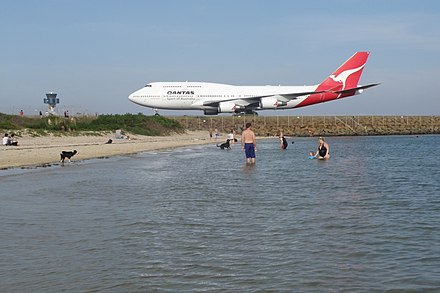Watch planes while metres away on the beach