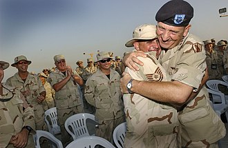 Gen. Tommy R. Franks, commander in chief, U.S. Central Command, embraces Tech. Sgt. Dan Fowler after addressing the troops of the 384th Air Expeditionary Group 384aeg-photo.jpg