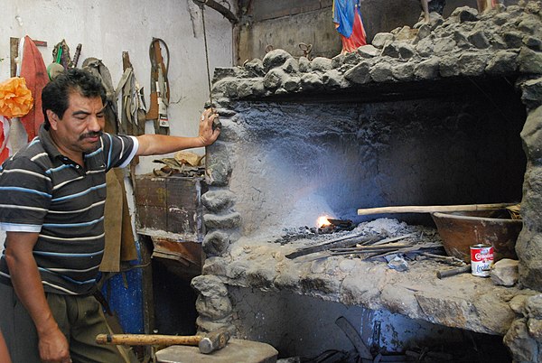 Blacksmith Apolinar Aguilar at the furnace of his blade workshop in Ocotlan de Morelos, Oaxaca, Mexico