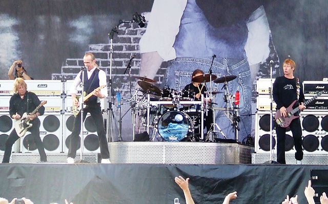 Performing at Arrow Rock Festival in Lichtenvoorde, the Netherlands in 2006; left-to-right: Parfitt, Rossi, Matt Letley (obscured by drums), John "Rhi