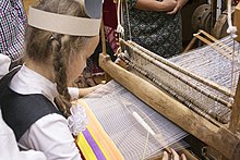 Passing the shuttle through the shed Belarus weaving.jpg