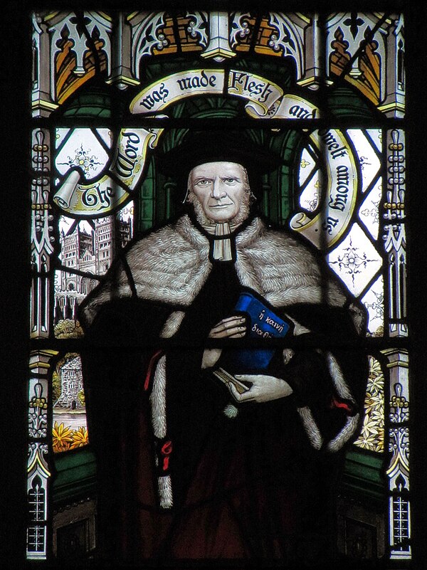 Bishop Westcott shown standing in front of Durham Cathedral in a window in All Saints Church, Cambridge.