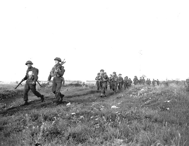 Men of the Royal Winnipeg Rifles on the march in Normandy, July 1944.
