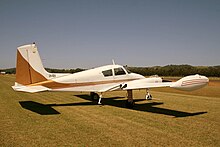 1957 Cessna 310B, with straight fin and overwing 'augmentor tube' exhaust system Cessna 310B (VH-REK) at Illawarra Regional Airport.jpg