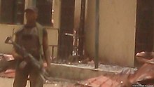 A Nigerian Army soldier at the destroyed school of Chibok after the kidnapping of 14 April 2014 Chibok kidnapping soldier on guard VOA.jpg