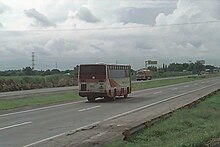 A 1999 view of the San Fernando segment of North Luzon Expressway, one of Marcos's infrastructure projects Dagupan Bus Aircon at NLEX 1999 - Flickr.jpg
