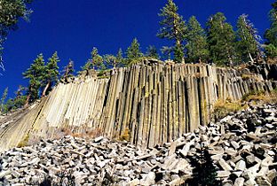 The longer fragments of basalt at the base of the cliff are much larger than a person