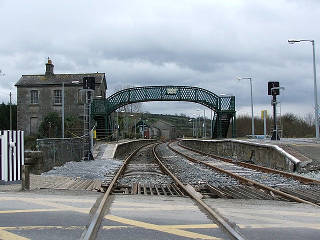 Railway tracks stretch into the distance from the level crossing at the eastern end of Farranfore station.