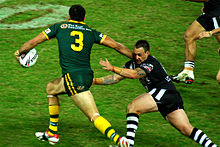 Inglis in action for the Kangaroos against the Kiwis in 2009 Greg Inglis and Nathan Fien (8 May 2009, Brisbane).jpg