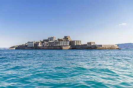 The abandoned island of Gunkanjima in Japan. Former coal-mine + city. Used to be the highest concentration of people in the world.