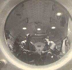 View from inside the hyperbaric chamber showing Naval dive doctors supervising a pressure test. Hyperbaric Pressure Chamber.jpg