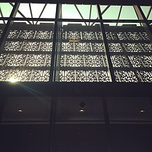The facade's 'scrim' viewed from the entrance lobby. Interior of the National Museum of African American History and Culture (NMAAHC) looking south.jpg