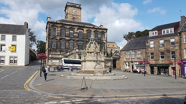 Linlithgow Town Centre, showing the Burgh Halls (background) and the Cross Well (foreground), August 2018