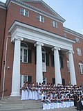 Class photo at graduation on the front steps of the main building