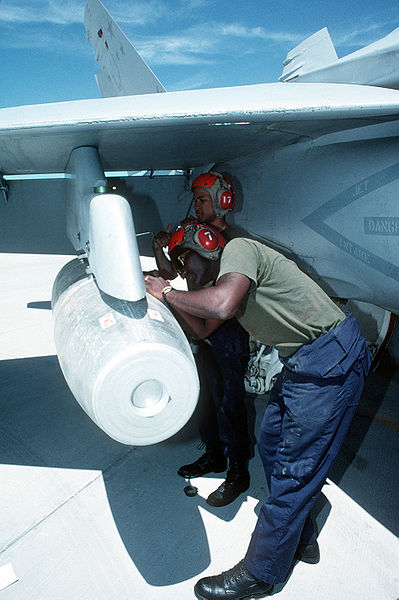 Mark 77 napalm bomb is loaded in a June 1993 training exercise onto a US Marine Strike Fighter Squadron F/A-18A Hornet aircraft