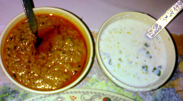 Two biryani accompaniments, mirchi ka salan and raita