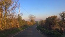 Toot Hill Road towards Clatterford End. The first farm can be seen on the bend. Road to Clatterford End from Toot Hill.jpg