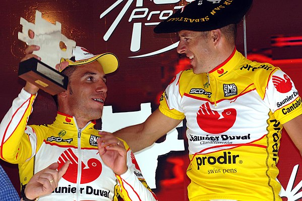 Joaquim Rodríguez and his teammate Constantino Zaballa, wearing the txapela, usually given to winners in the Basque Country.