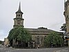 A Georgian style church seen from the south with round-headed windows and a tower on the left surmounted by a spirelet