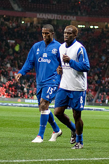 Saha (right) alongside Sylvain Distin with Everton in 2009 Sylvain Distin Louis Saha vs ManU 2009.jpg