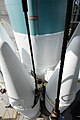 Technicians between heavy booster and Delta II first stage.jpg