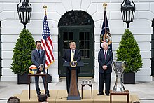 Penske (right) with President Donald Trump (center) and Joey Logano (left) on the White House south lawn in 2019 The 2018 NASCAR Cup Series Champion Joey Logano Visits the White House (40783463503).jpg