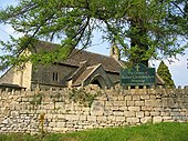 View of the church with a dry stone wall