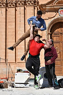 Maltese strongman Tony Farrugia performing his human dumbbell feat during a performance in Mellieha, Malta. Tony farrugia strongman human dumbbell.jpg