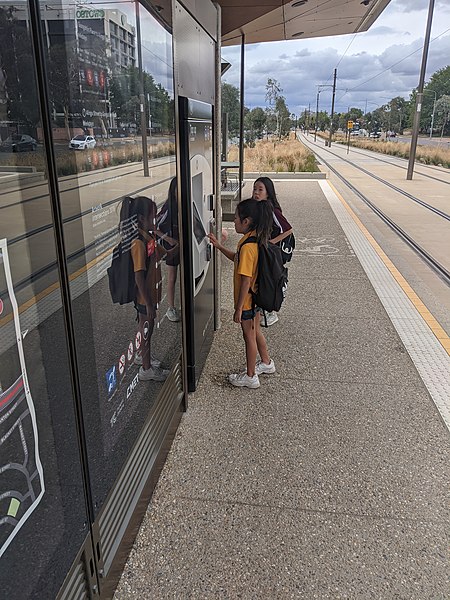 File:Tots using ticket machine at Dickson Interchange light rail stop, Canberra.jpg