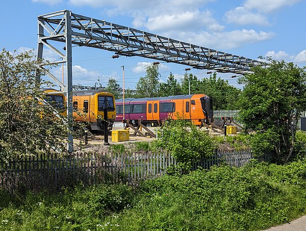 Class 730 unit alongside two Class 323 units at Soho Depot.