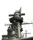 The tower is dominated by a large radar set; two long arms protrude from the side of the tower.