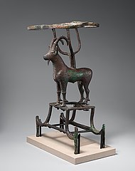 Vessel stand in the shape of an ibex. Copper-based alloy with nacre and lapis lazuli inlays, created with the lost-wax method (ED III)
