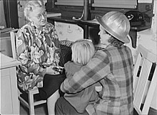 Midnight-shift shipyard worker Arlene Corbin (right) brings her daughter to a day care facility before going home to sleep WWII daycare Richmond CA.jpg