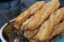 Several sticks of fried dough laid on top of one another