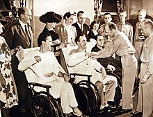 An injured pilot received the Distinguished Flying Cross at Walter Reed Hospital from Maj. Gen. Millard F. Harmon in 1942. 111-SC-21321AC (34281999011).jpg