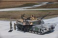 U.S. Marines with 2nd Tank Battalion, 2d Marine Division (MARDIV) conduct a simulated casualty evacuation on an M1A1 Abrams tank during a Tank Table 12 qualification at Camp Lejeune, North Carolina, March 11, 2020. The qualification requires offensive and defensive tactics to improve and test the MarinesвЂ™ ability to make quick and conclusive decisions. (U.S. Marine Corps photo by Lance Cpl. Reine Whitaker)